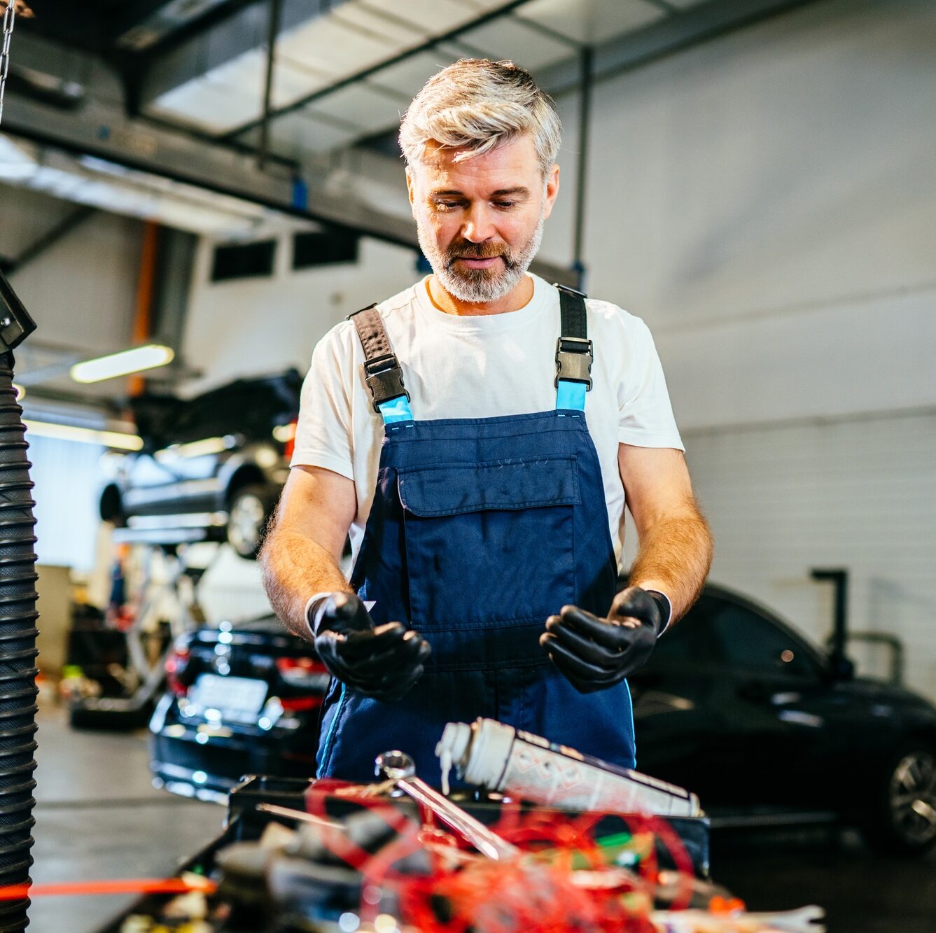 Handsome male worker finding the perfect tool.